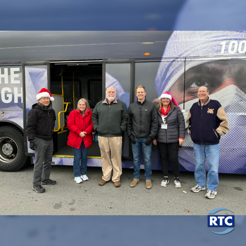 Image of RTC employees in front of bus gathering food donations.