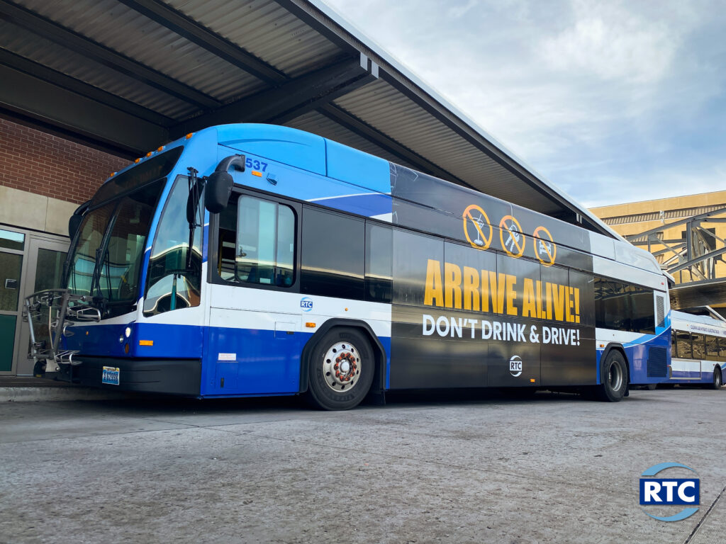 A picture of an RTC Bus with a sign saying "Arrive Alive, Don't Drink and Drive"
